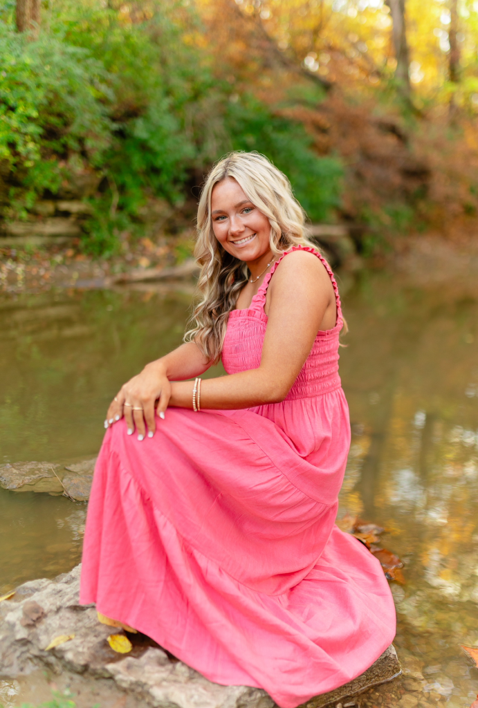 Sunsations spray tan client posing for senior photos before a special event